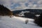 Winter trail in Jeseniky mountains in Czechia during nice winter day with clear sky. Wiew of Czech typical village and trees cover