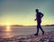 Winter training. Runner in winter landscape with blue sky