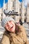 Winter travel, vacations and birds concept - Young happy woman tourist with funny pigeons making selfie photo in front