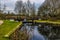 Winter trees reflected in the top lock at Foxton Locks, UK