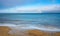 Winter view of Baltic sea with beach and rainbow over maritime horizon offshore Gdynia Orlowo district of Tricity in Poland