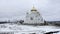 Winter view. Clip. Snow strewn on the road and a large white Orthodox church with golden domes.