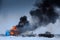 Winter view of the german tanks panzers with burning house in the battle.