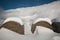 Winter view of hay bales with snow in the Pian Grande near Castelluccio di Norcia, Umbria