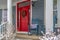 Winter view of home with red door and front porch