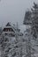 Winter view of Kramarova chata building and an observation tower at Suchy vrch mountain, Czech Republ