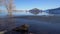 Winter view of a lake at foothils of Rocky Mountains with a stand up paddler