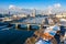 Winter view of Moskva river, Novospasskiy Bridge, and skyscrapers on a sunny morning. Ice floes, blocks of ice, snow on roofs.