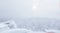 Winter view from the top of the mountain to the snowy wooded hills in frosty fog, cell towers are visible in the distance