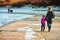 Winter walk by Baltic sea, mother and daughter