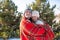 Winter walk through the woods. The guy in the red plaid blanket wraps the girl up so she gets warm