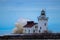 Winter waves striking a lighthouse and entrance light.