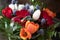 Winter wedding bouquet - red chrysanthemum, orange tulips, blue thistle and fern leaves arrangement