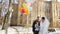 Winter wedding, happy, laughing newlyweds with bright, multi-colored balloons. sunny snowy day, the ancient architecture