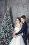 Winter Wedding .Lovers bride and groom in christmas decoration . HGroom and bride together. couple hugging. Wedding day.