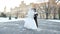 Winter wedding. newlywed couple in wedding dresses are dancing wedding dance in a snow-covered park, against the