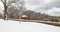 Winter white snow covered road sign with directions on slope