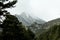 Winter in winter Pyrenees mountains. Blizzard and snow-covered mountain peaks on background