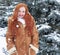 Winter woman outdoor portrait, snowy fir trees background