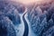 Winter wonderland aerial view of curvy road in snow covered forest