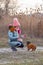 Winter. young girl in warm clothing. Teenage girl playing with her dog. Chihuahua with girl