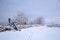 Winterland with a stile at a stone wall