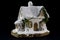 Winters christmas decoration with small toy ceramic house