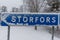 A wintery cross road with a sign