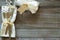 Wintry Christmas Table Place Setting with Snowflake napkin, Silver present with white bow and berries, all on rustic wood boards b