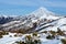 Wintry mountainous landscape - snow-capped cone of volcano