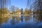 A wintry scene in Berlin, Germany, district Lichtenrade, with a village pond in the foreground and a small manor in the background