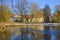 A wintry scene in Berlin, Germany, district Lichtenrade, with a village pond in the foreground and a small manor in the background