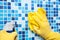 Wiping bathroom wall with cleaning cloth and sprayer - house chores