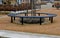 wire circular benches park furniture in winter. sintered gravel with