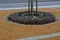 wire circular benches park furniture in winter. sintered gravel with