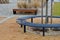 wire circular benches park furniture in winter. sintered gravel with