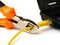 Wire cutter cutting network cable from laptop on white background