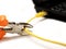 Wire cutter cutting network cable from laptop on white background