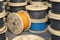 Wire electric cable on wooden coil or spool isolated on warehouse