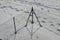 Wire fence with barbed wire. On a snowy meadow is a fence with metal posts and wire mesh. view from above. protective fence of pri