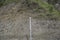 A wire fence at the foot of the hill to guard against falling stones