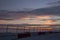 Wire fence with a sunset colored sky in background