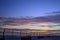 Wire fence with a sunset colored sky in background