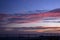 Wire fence with a sunset colored sky in background