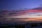 Wire fence with a sunset colored sky in background