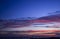 Wire fence with a sunset colored sky in background