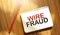 WIRE FRAUD of the box on notebook on wooden background