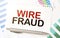 WIRE FRAUD on paper sheet and charts