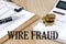 WIRE FRAUD text with chart and calculator and coins , business concept