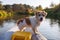 A wire-haired Jack Russell terrier stands on the bow of a red water kayak. Dog in nature on board a boat. Animal on a